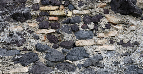 Wall of mixed material using local black volcanic rocks, background  (Kaiserstuhl, Germany)