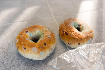 Moldy bagel on the  floor