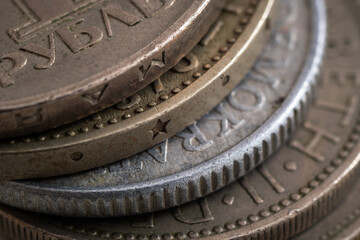 Stacked various coins close up, uncirculated coins with corrosion, dents and scratch damage, edges...