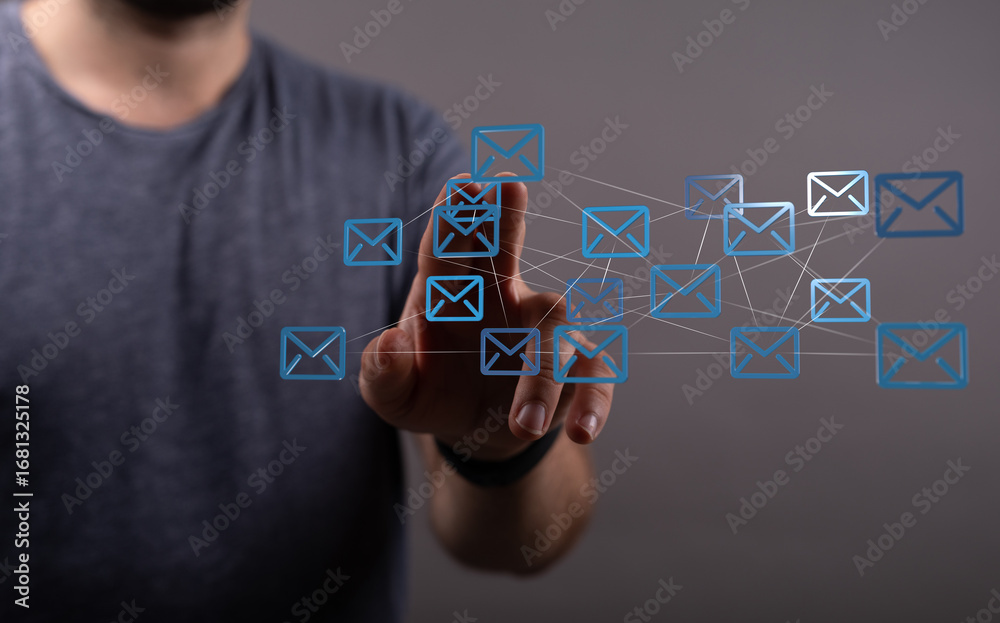 Wall mural abstract image of a person interacting with a digital network of email icons, representing communica