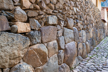 Detail view with the Inca walls made of cut stones in Ollantaytambo Sacred Valley, Peru.