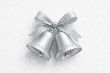 Pair of shiny silver bells against a white backdrop