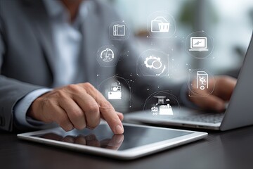 Businessman using tablet and laptop, surrounded by digital process icons