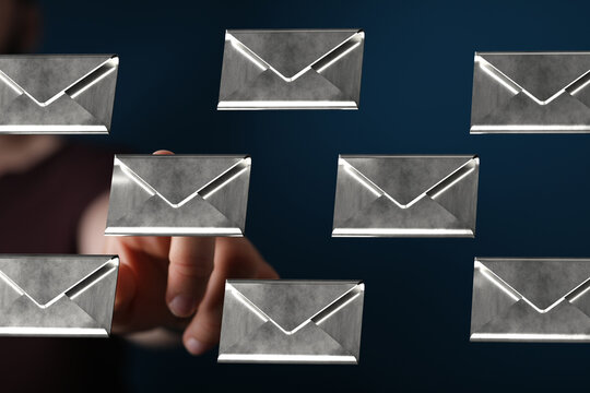Person interacting with digital email envelopes, showing inbox management.