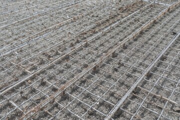 Fototapeta premium Steel reinforcement grid placed on decking, prepared for concrete casting.