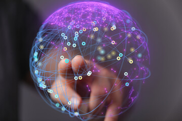 Abstract image of a hand interacting with a digital globe, representing global networking and connection.