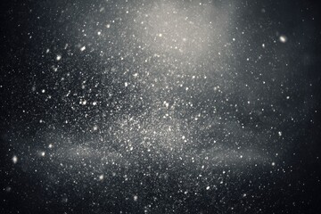 Dark backdrop with many tiny light specks, resembling snowfall or cosmic dust