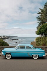 Fototapeta premium Classic turquoise car parked seaside on the Oregon coast vintage automobile scenic view travel destination automotive photography