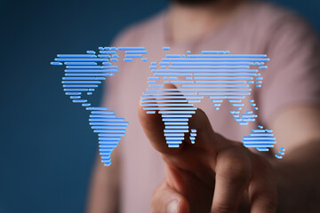 Person touching a digital world map, illustrating global connectivity and technology.
