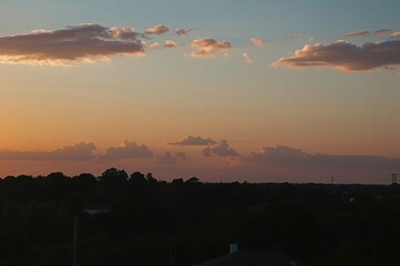 Photos of the twilight sky and surroundings near a home with power lines.