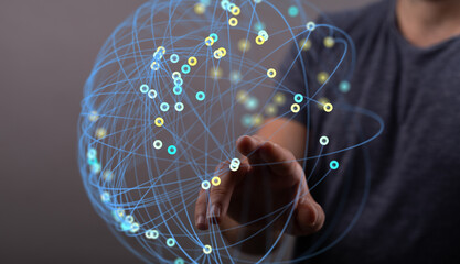 Hand interacting with a digital sphere, representing global network connections and data flow.