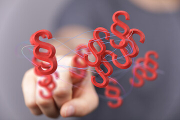 Abstract image of a hand interacting with floating 3D paragraph symbols, representing legal...