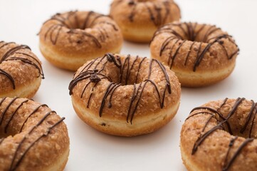 Fototapeta premium Chocolate raisin donuts isolated on a white surface, breakfast dessert from bakery
