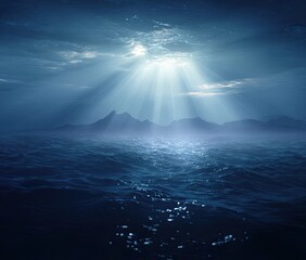 Underwater scene of dark blue ocean waves, sunlight rays piercing through cloudy sky, and distant mountains