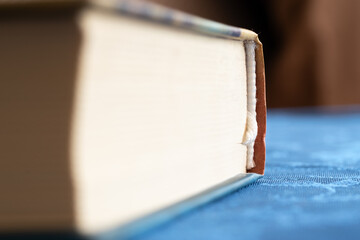 Book on table close up with hardcover, book spine in focus