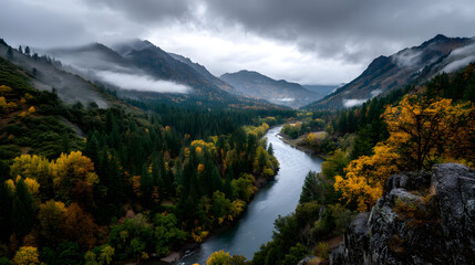Fototapeta premium A panoramic river view flowing through vibrant autum valleys, with misty mountins in the background and olden leaves in the foregrund.
