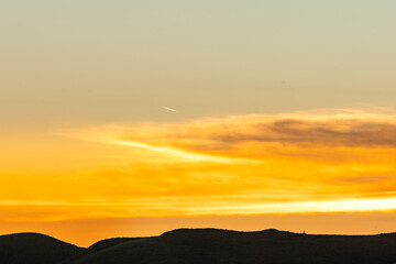 Evening in the Sumba Savanna unites the rolling hills, an ancient church, and a golden sky