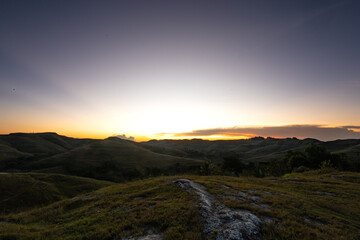 Evening in the Sumba Savanna unites the rolling hills, an ancient church, and a golden sky