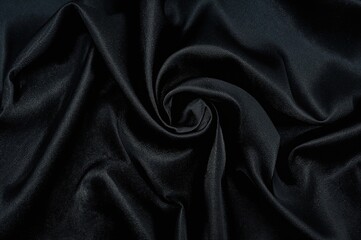 Obraz premium High-quality abstract textile background with a smooth, luxurious black satin-like texture.