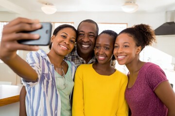 Obraz premium Cheerful African American Family Creating Digital Memories with Family Selfie