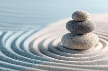 Stacked stones on a sand zen garden