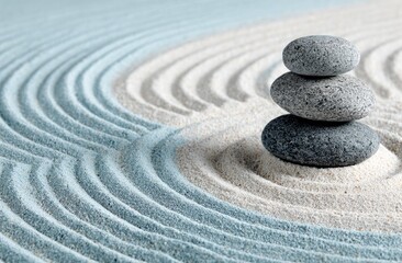 Stacked stones on a light sand zen garden