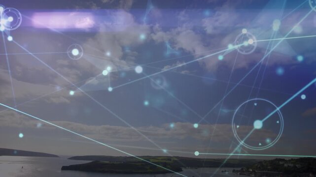 Animation of network of connections over green countryside and blue sky with clouds