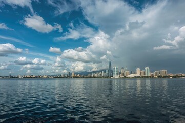 Naklejka premium Wide-angle scenery following a rainfall with water, sky, travel, urban area, nature, structures, greenery, design, and rainbow elements