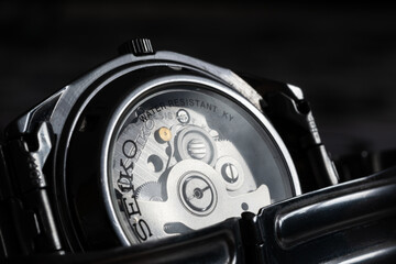 Back case of wrist watch close up, transparent crystal glass and automatic movement mechanism