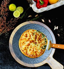 Double-topped pizza with melted cheese and fresh spinach, freshly baked with a golden crispy crust