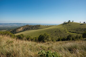 Fototapeta premium Wide-angle view of rolling hills along a coastal region