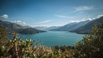 Obraz premium Landscape featuring a large reservoir nestled among mountain ranges