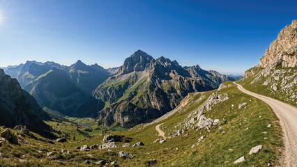 Obraz premium Vista of untamed mountain ridges viewed from an unpaved road heading to a countryside village and an adjacent peak in the highlands