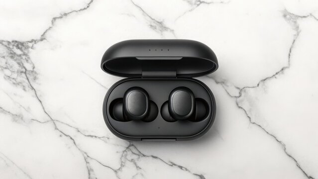 Sleek black true wireless earbuds with charging case presented on a white marble surface