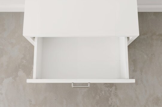 Overhead perspective of an open, empty drawer in white furniture, suitable for living room or workspace mockup