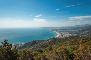 Aerial perspective of coastal mountains beside the sea from a cable car ride