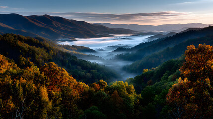 A stunning autumn view of the mountains bathed in goden light, with morning fo slowly dispersing over th valley.
