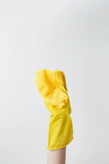 Yellow cleaning products, the woman cleans using rubber gloves and a microfiber cloth. Household cleaning and hygiene concept