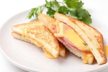 Delicious sandwiches with melted cheese and ham on white table, closeup