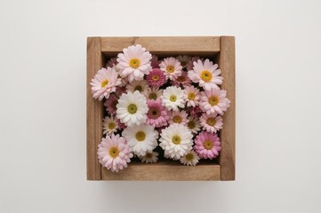 Floral arrangement emerging from an open wooden container, viewed from above, featuring natural beauty and spa elements