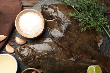 Fresh flounder fish, spices and products on wooden table, flat lay. Raw seafood