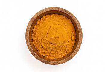 Overhead view of ground turmeric in a wooden container on a white surface