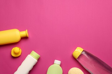 Baby bath accessories and care products on crimson background, flat lay. Space for text