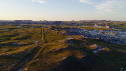 Vast Badlands Landscape Drenched in Golden Evening Light by Drone 