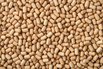 Fototapeta premium Close-up of wooden pellet texture for animal bedding on a white backdrop.