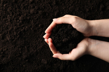Woman with pile of fresh soil, top view