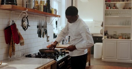 Frying pan, cooking and meat with black man in kitchen for personal chef, nutritionist and meal prep. Healthy food, dining and home cook with person in house for steak, dinner and cuisine protein