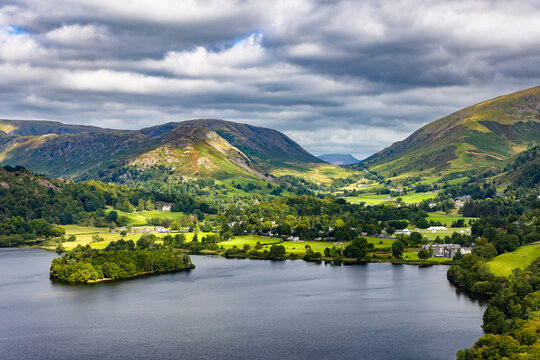 Dramatic cloudy sky over the green hills and lake at Grasmere, Lake District, England