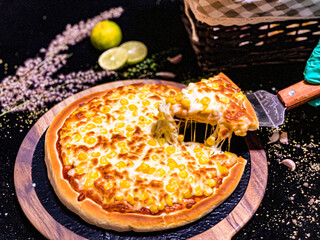 A hot pizza with gooey, stretchy melted cheese, freshly baked with a crispy golden crust.