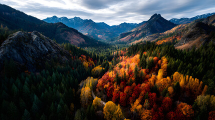 Aerial view of red and gold trees cascading across atumn mountain ranges.